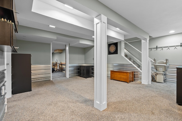 finished below grade area featuring stairs, recessed lighting, and carpet floors