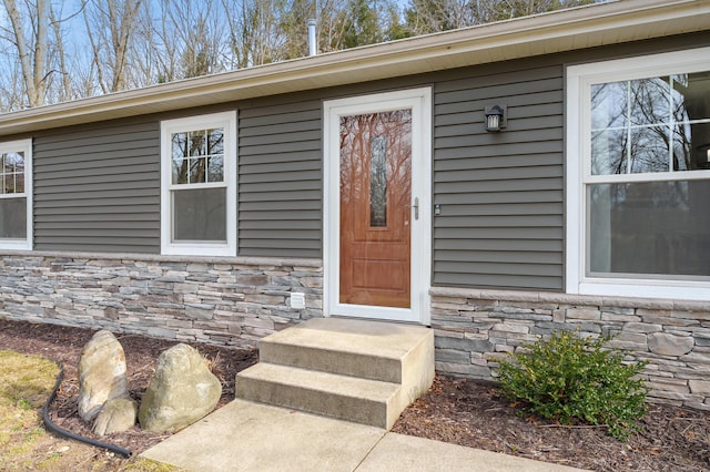 entrance to property with stone siding