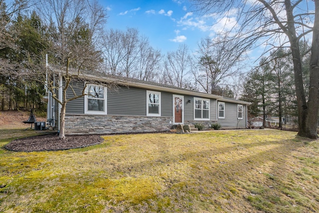 ranch-style house featuring stone siding, a front yard, and entry steps