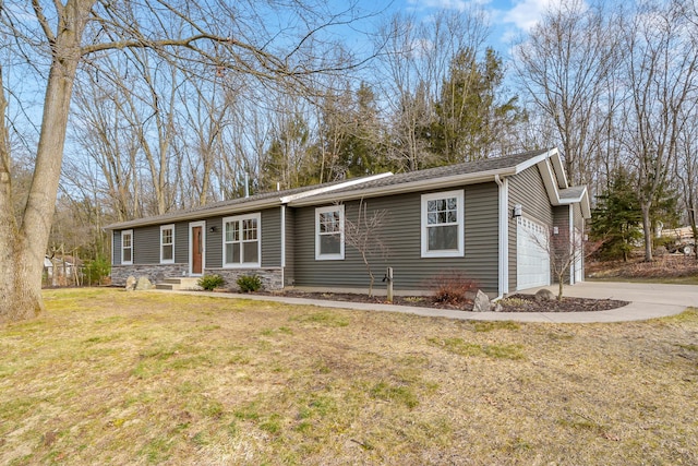 ranch-style home with stone siding, driveway, a front yard, and a garage