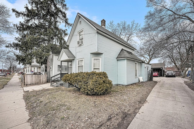 view of side of property featuring a shingled roof