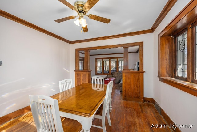 dining room featuring ceiling fan, baseboards, wood finished floors, and crown molding