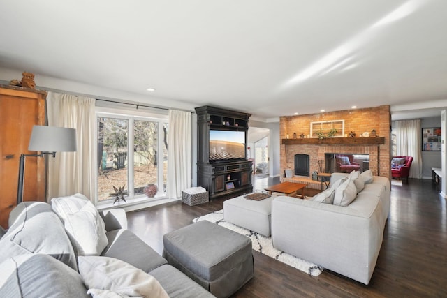 living area featuring recessed lighting, a fireplace, and dark wood-style flooring