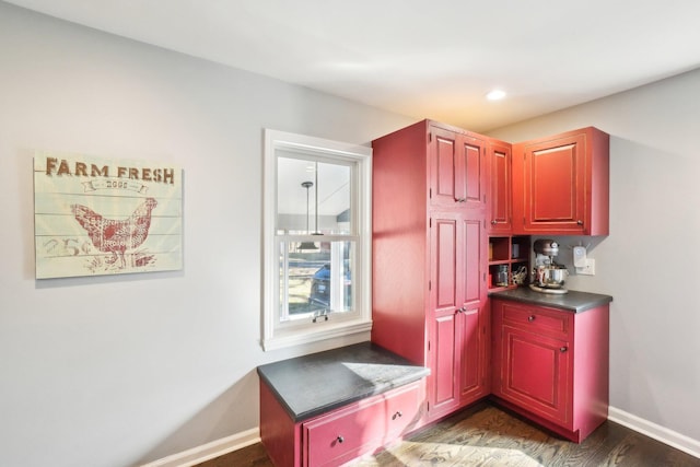 interior space with dark countertops, recessed lighting, baseboards, and dark wood-type flooring