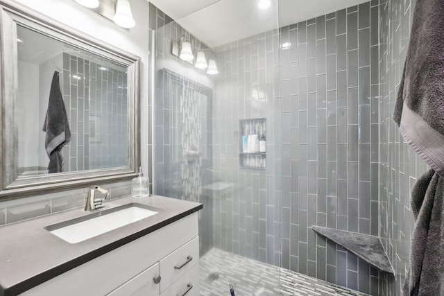 bathroom with backsplash, vanity, and walk in shower