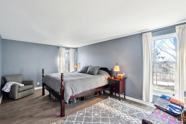 bedroom with baseboards and wood finished floors