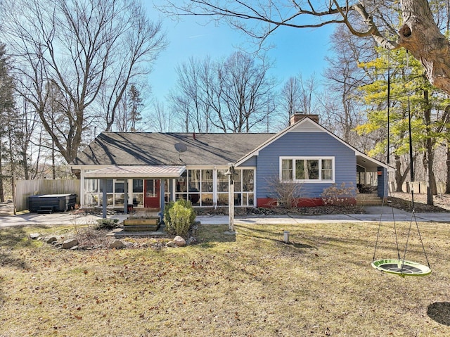 back of property featuring a yard, fence, and a chimney