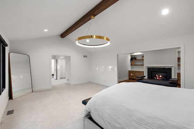 bedroom featuring visible vents, vaulted ceiling with beams, baseboards, light colored carpet, and a glass covered fireplace