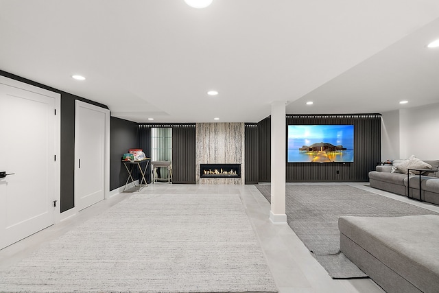 cinema featuring recessed lighting, baseboards, a large fireplace, and an accent wall