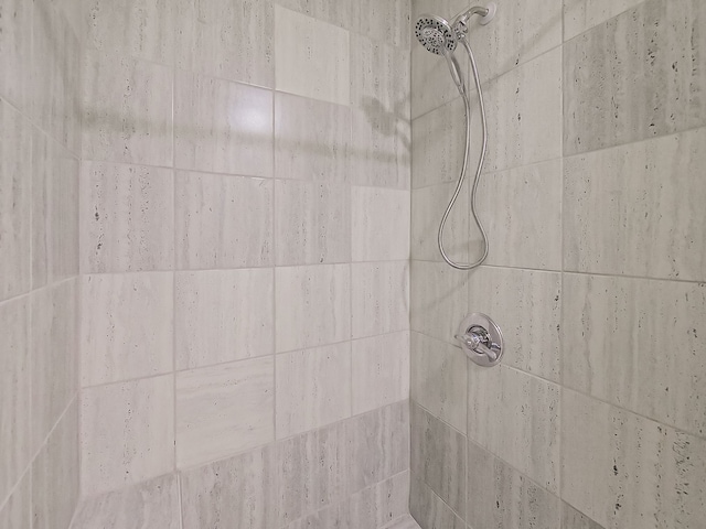 full bath with a tile shower