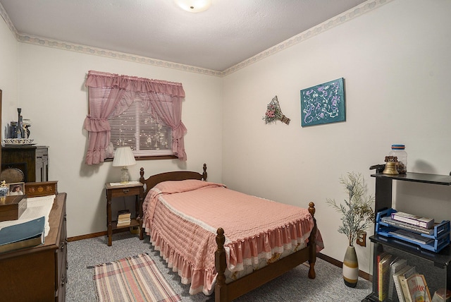 bedroom with baseboards and carpet