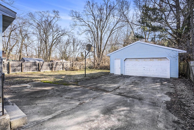 detached garage featuring fence