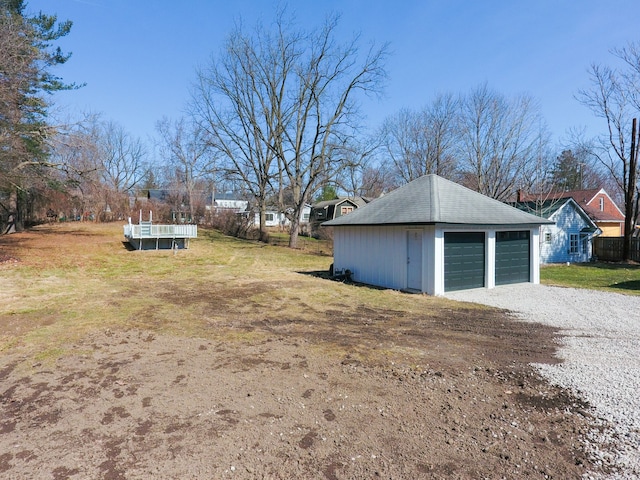 view of yard with a detached garage and an outdoor structure