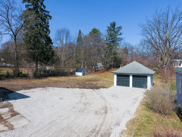 view of yard with a garage and an outdoor structure