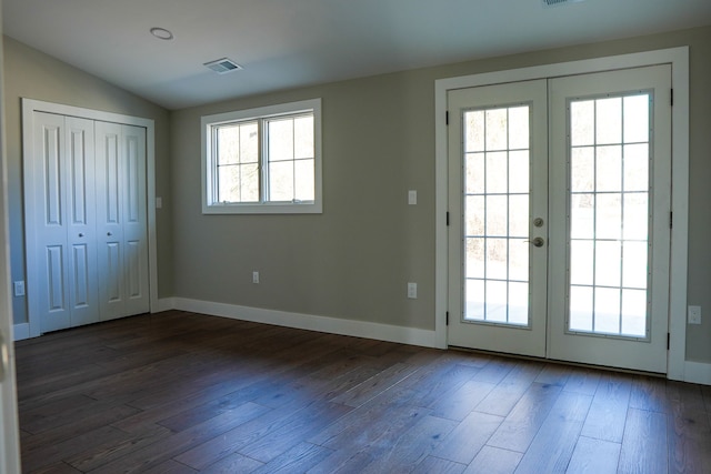 entryway with wood finished floors, baseboards, visible vents, vaulted ceiling, and french doors