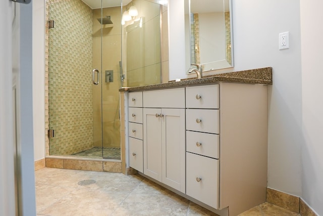 bathroom featuring a stall shower and vanity