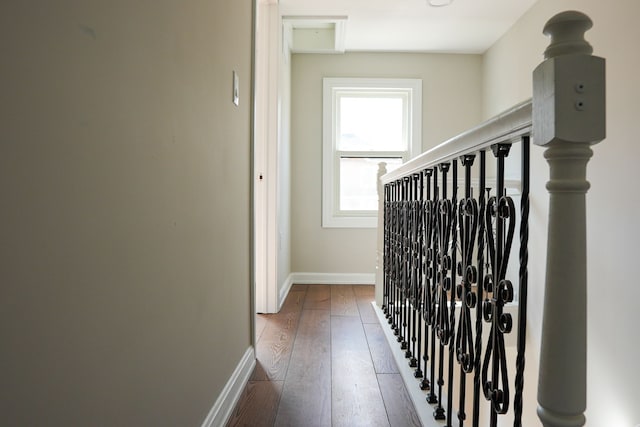 hall with stairs, baseboards, and wood-type flooring