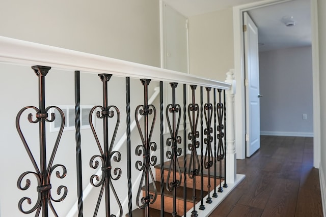 corridor with dark wood-style floors and baseboards