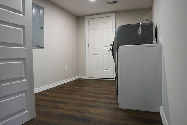 clothes washing area featuring visible vents, electric panel, dark wood-style floors, and baseboards