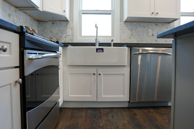 kitchen with a sink, tasteful backsplash, dark wood finished floors, white cabinetry, and dishwasher