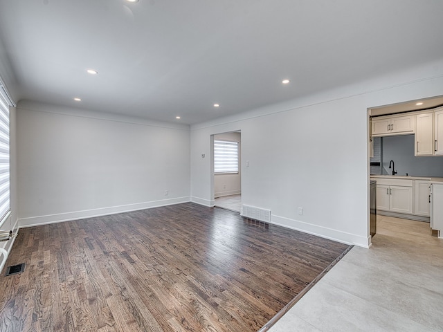 unfurnished living room with visible vents, recessed lighting, light wood-style flooring, and baseboards