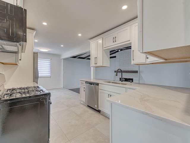 kitchen featuring black range with gas stovetop, light stone counters, stainless steel dishwasher, white cabinetry, and a sink