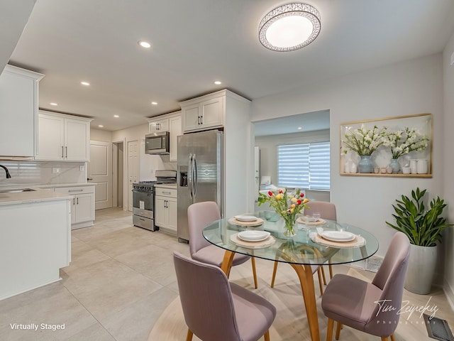 dining room featuring light tile patterned floors, visible vents, and recessed lighting