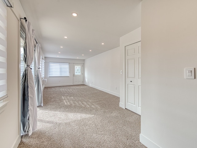 unfurnished room featuring recessed lighting, baseboards, and light colored carpet