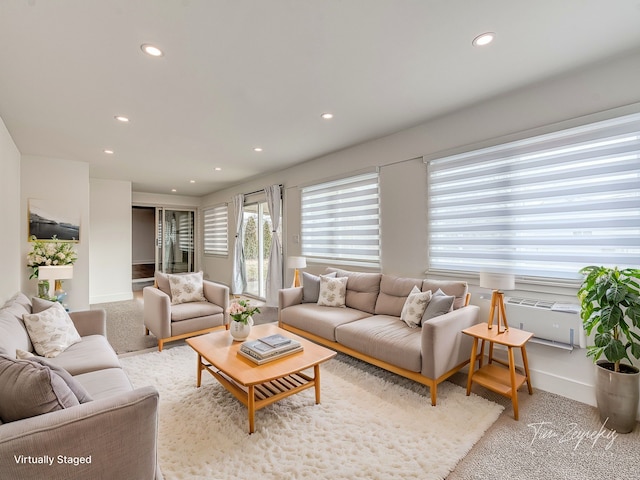 living room featuring recessed lighting, light colored carpet, and baseboards