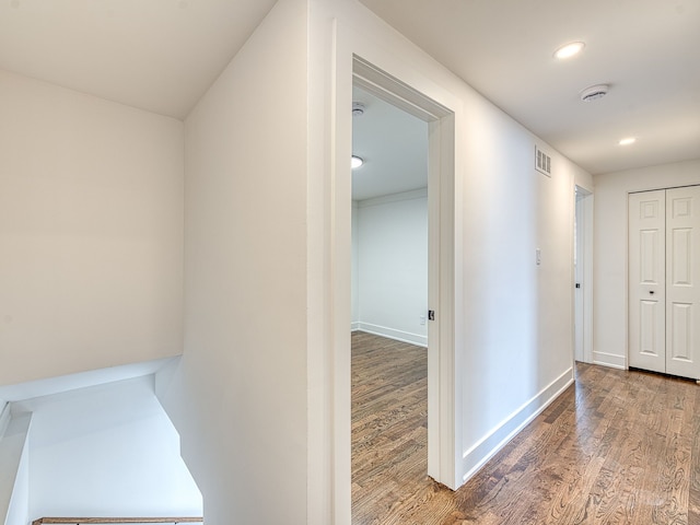 hallway featuring recessed lighting, wood finished floors, visible vents, and baseboards