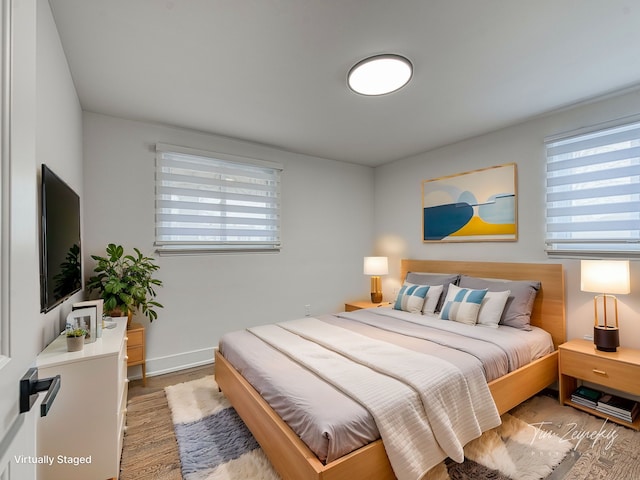 bedroom with wood finished floors and baseboards