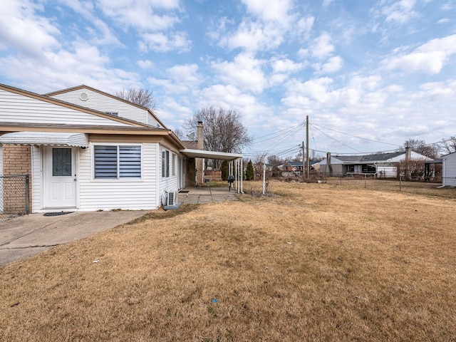 view of yard with an attached carport and fence