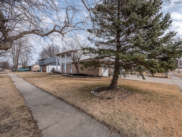 view of front of home with a front lawn and brick siding