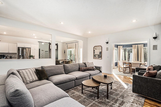 living room featuring recessed lighting, wood finished floors, and baseboards