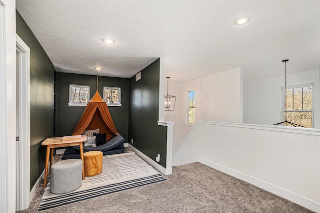 game room with a healthy amount of sunlight, baseboards, an inviting chandelier, and carpet floors