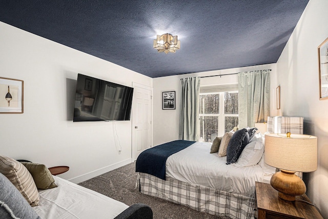 carpeted bedroom featuring a textured ceiling and baseboards