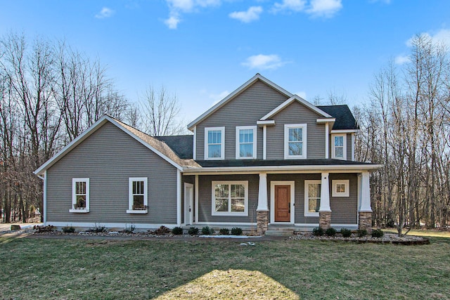 craftsman-style home featuring covered porch and a front yard