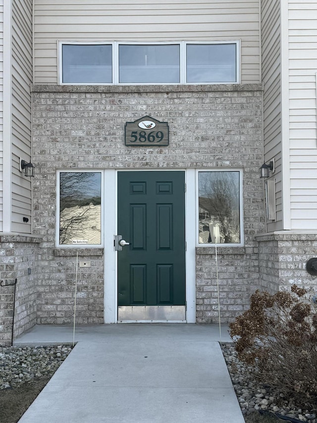 doorway to property featuring stone siding