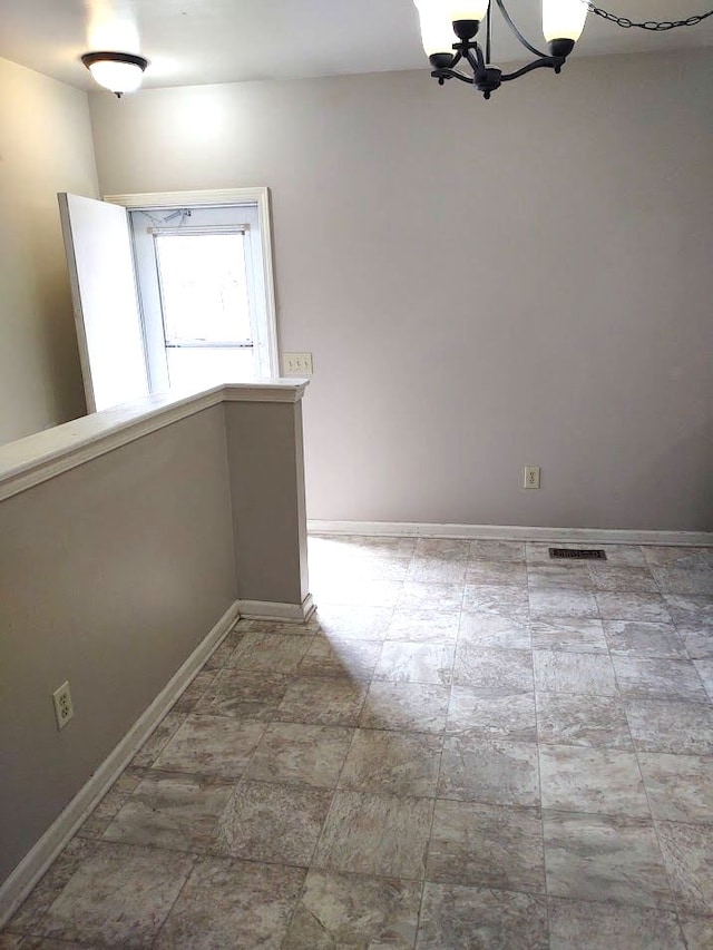 21641 Jacksonville St, Farmington Hills, MI 48336 - empty room featuring visible vents, baseboards, and a chandelier