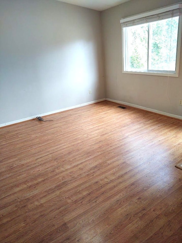 21641 Jacksonville St, Farmington Hills, MI 48336 - empty room with visible vents, baseboards, and wood finished floors