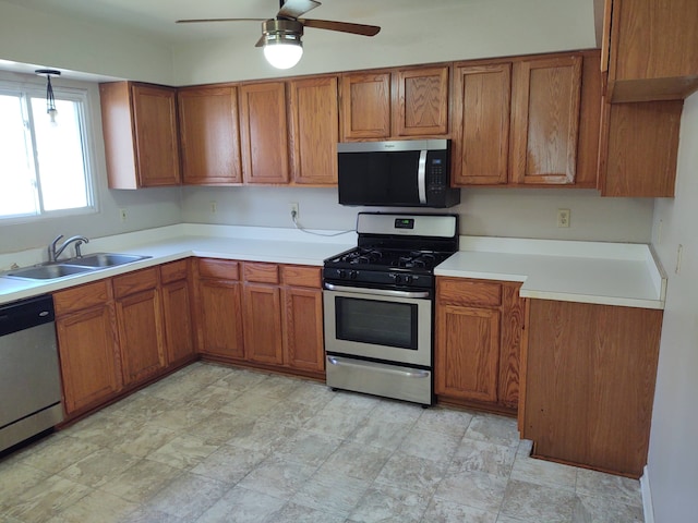 21641 Jacksonville St, Farmington Hills, MI 48336 - kitchen featuring light countertops, brown cabinets, appliances with stainless steel finishes, and a sink