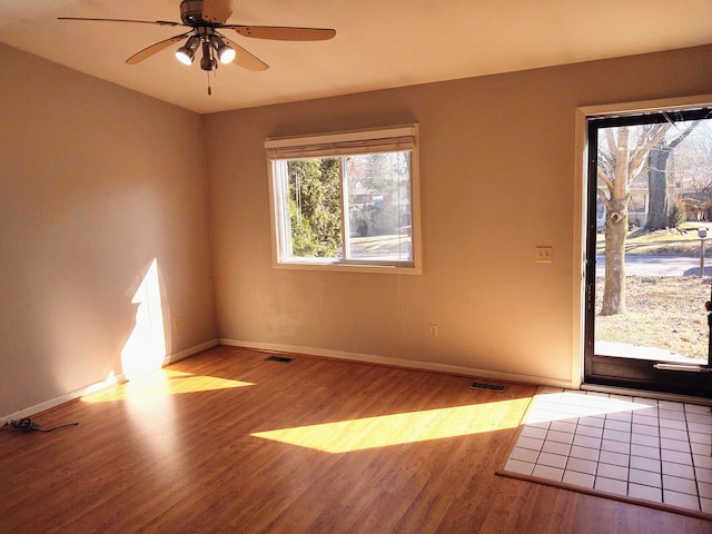 21641 Jacksonville St, Farmington Hills, MI 48336 - spare room featuring visible vents, ceiling fan, baseboards, and wood finished floors