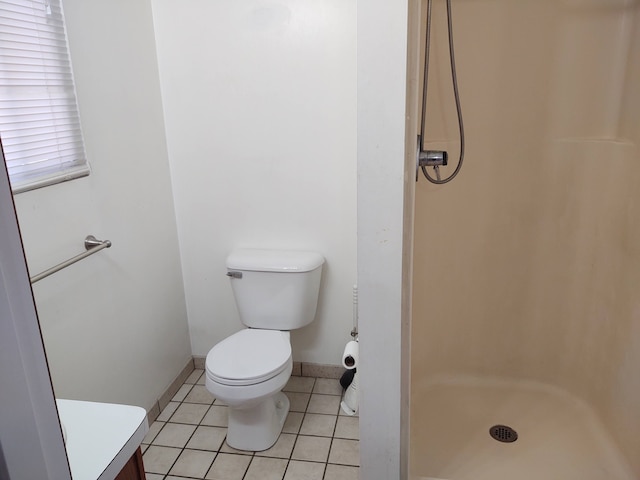 21641 Jacksonville St, Farmington Hills, MI 48336 - bathroom with vanity, baseboards, a stall shower, tile patterned floors, and toilet