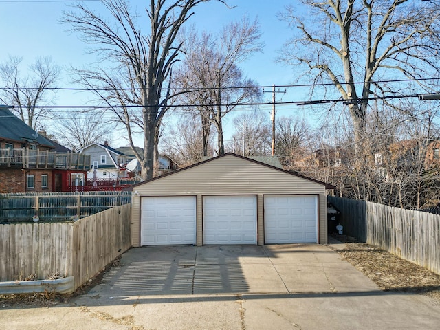 detached garage featuring fence