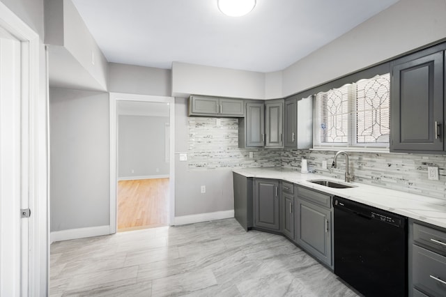 kitchen with black dishwasher, gray cabinets, and a sink