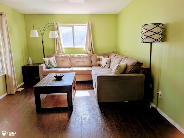 living room with dark wood-style floors and baseboards