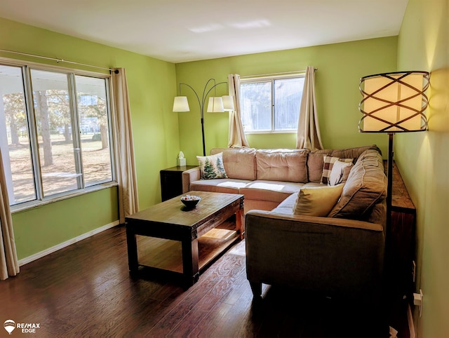 living room featuring dark wood-style floors and baseboards