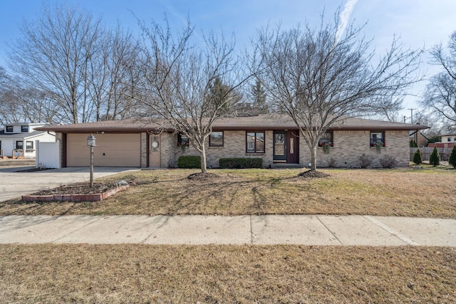 view of front of home featuring a front yard, brick siding, a garage, and driveway