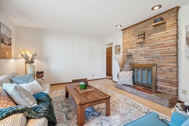 living room with a stone fireplace, recessed lighting, baseboards, and carpet floors