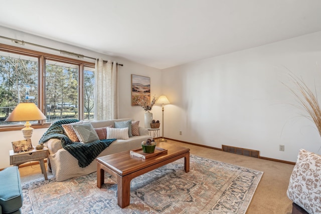 living room with baseboards, visible vents, and carpet floors